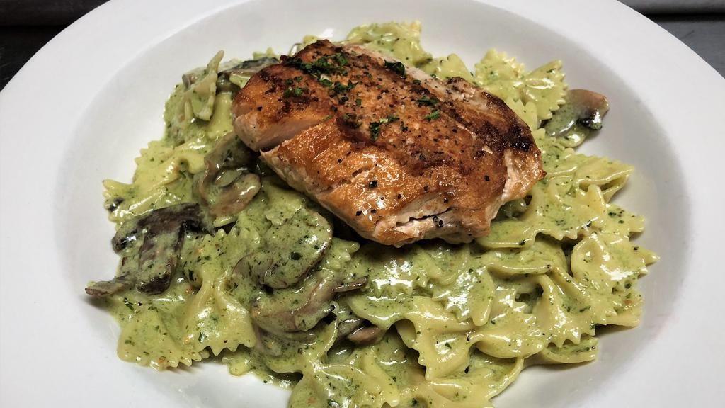 Salmon Pesto Pasta · Bowtie pasta and sautéed mushrooms tossed in our housemade pesto sauce and topped with grilled  Atlantic salmon and Parmesan cheese.