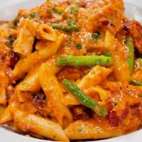 Penne Alla Vodka With Chicken · Penne pasta tossed with garlic, olive oil, sun-dried tomatoes, asparagus, tomatoes sauce wit...