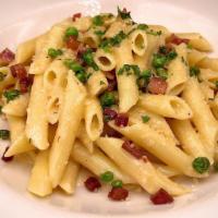 Penne Alla Carbonara · Tossed in our creamy carbonara sauce w/diced pancetta, Peas and fresh parmesan