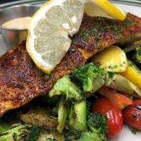 Salmon A La Verdure · Grilled Blackened Atlantic Salmon on a bed of Fresh Sautéed Vegetables of Zucchini, Yellow S...
