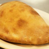 Calzone · Oven baked folded pizza dough, stuffed with ricotta cheese, mozzarella cheese, and a slice o...