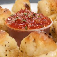 Garlic Knots (8Ct) · Fluffy pizza dough hand tied into knots,. then tossed in our unique blend of. garlic, season...