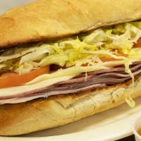 Classic Italian Sub · Three slices of ham, salami & provolone, topped with lettuce and tomato on a toasted baguett...