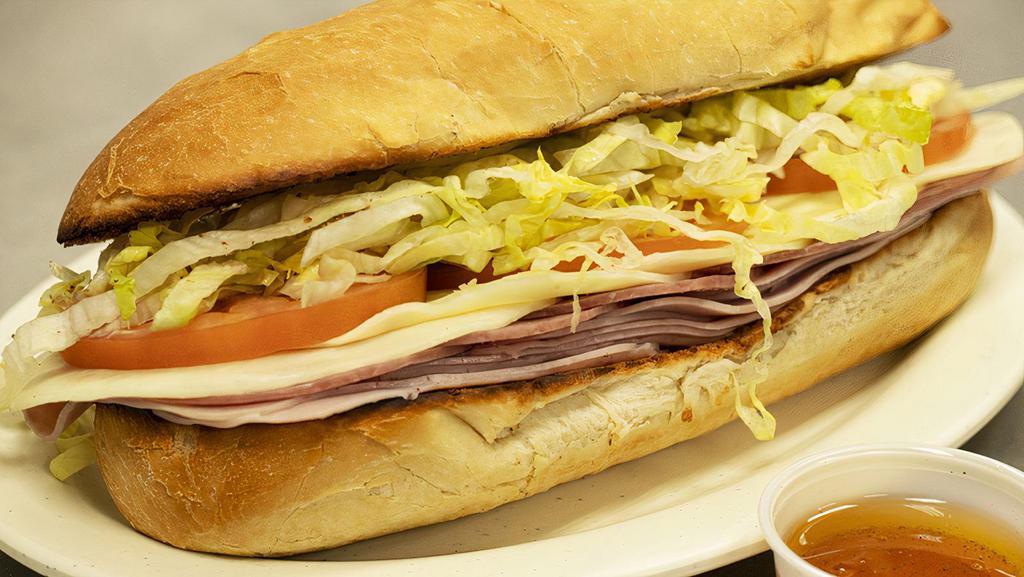 Classic Italian Sub · Three slices of ham, salami & provolone, topped with lettuce and tomato on a toasted baguette. Served with italian dressing.