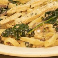 Chicken Florentine · Chicken breasts sauteed with garlic, mushrooms, onions and spinach in a creamy white wine sa...