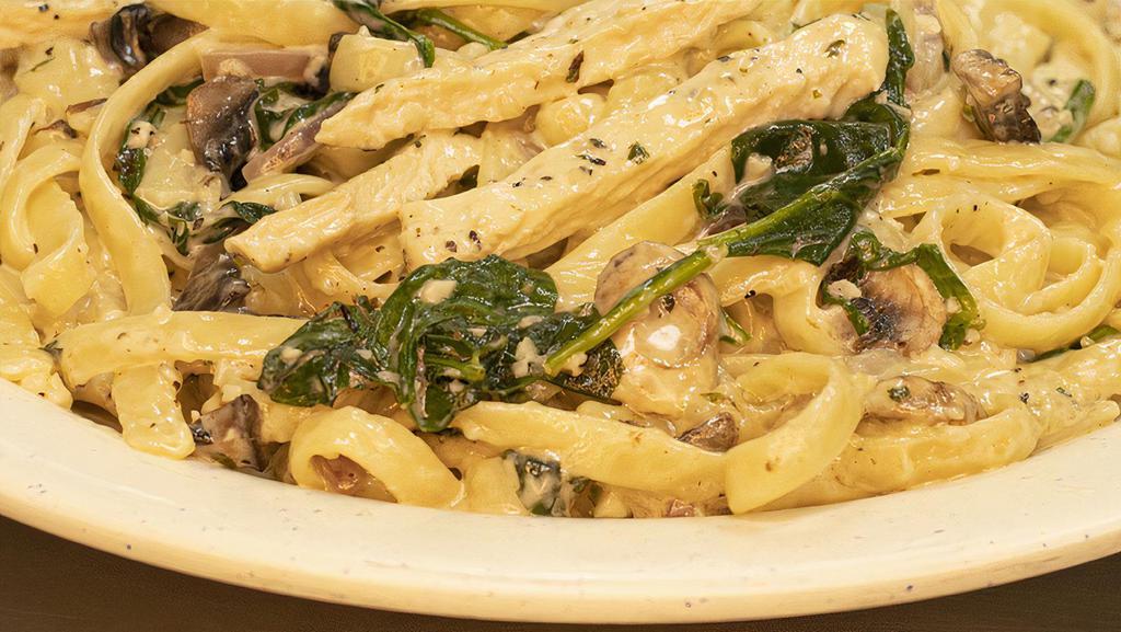Chicken Florentine · Chicken breasts sauteed with garlic, mushrooms, onions and spinach in a creamy white wine sauce, served over fettuccine pasta.