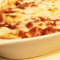 Manicotti · Pasta sheets rolled and stuffed with a mixture of cheeses & herbs, baked with mozzarella che...
