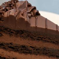 Chocolate Mousse Cake · Rich chocolate cake and mousse covered in chocolate buttercream icing with milk chocolate sh...
