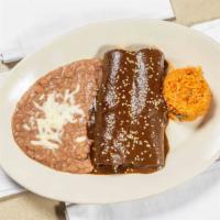 Enchilada De Mole · Two chicken enchiladas topped with traditional homemade mole. Served with rice and beans.