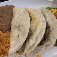 Tacos Al Carbon · Marinated and grilled beef and chicken breast sliced thin and rolled in a flour tortilla. Se...