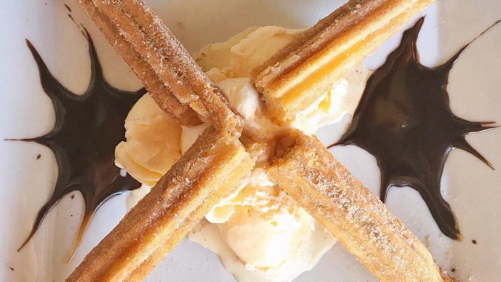 Churros Filled With Mexican Cajeta · Served with vanilla ice cream.