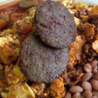 Migas · Eggs, tomatoes, onions, and cheese scrambled together and served with sausage, pinto beans, ...