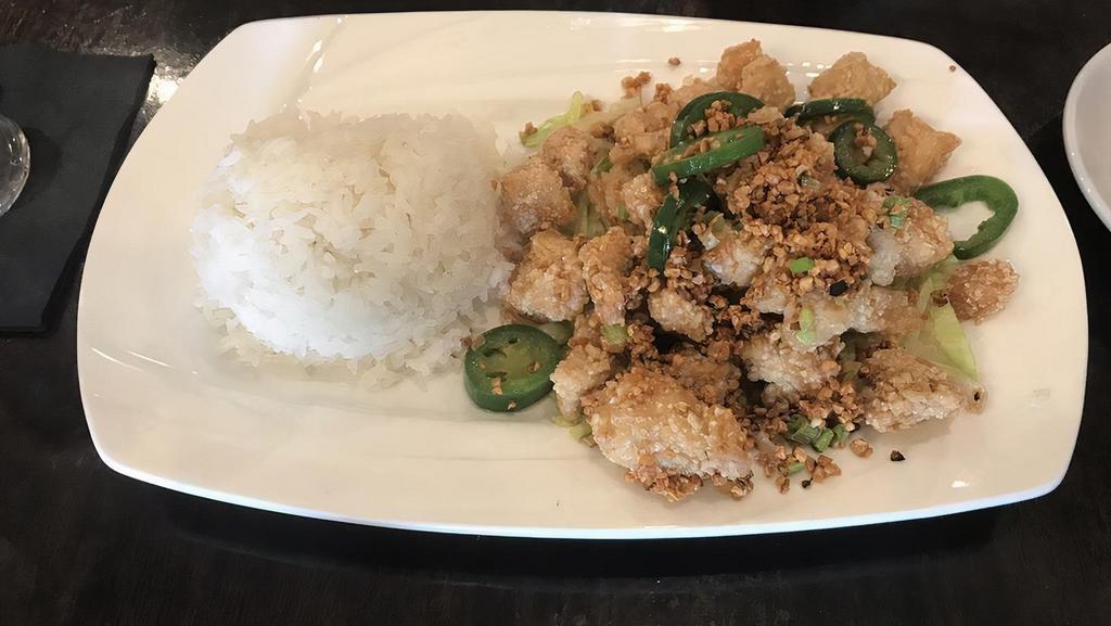 Salt & Pepper Chicken · Light breaded white meat chicken cubes in sweet potato flour, stir-fried with roasted garlic and jalapeños.