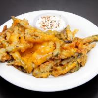 Texas Toothpicks · Fresh (not spicy) jalapeño strips, breaded and deep-fried, covered in melted cheddar cheese....