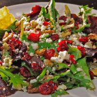 Uptown Salad · Sweet baby green lettuce mix, walnuts, craisins, and a mild feta cheese, topped with a baked...