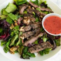 Sleezy Steak Salad · 7 ounces of our rib-eye atop a generous portion of mixed greens and wedge tomatoes, we add t...