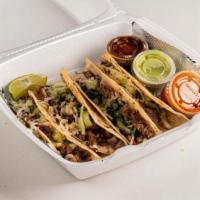 Caramelo Suadero · Suadero tacos with a fine thin flour taco tortilla. Filled with cheese and carne asada. On t...
