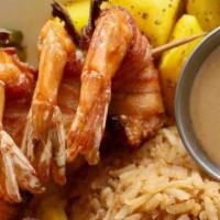 Shrimp Brochette Mexicana · Bacon-wrapped shrimp with jalapeño, served over a bed of sauteed mango relish with charro be...