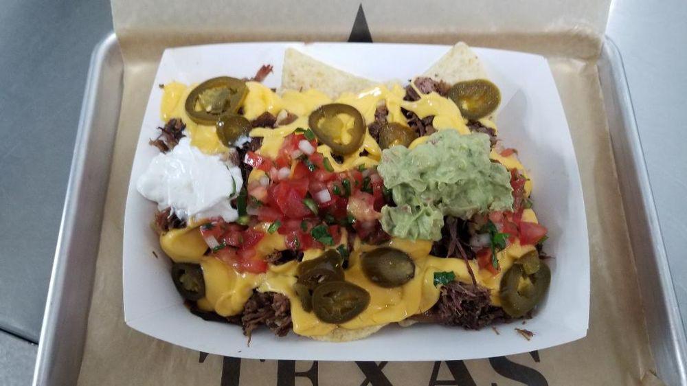 Loaded Nachos · Chips, Queso, Beans, Pico De Gallo, Sour Cream, & Jalapenos topped with choice of meat.