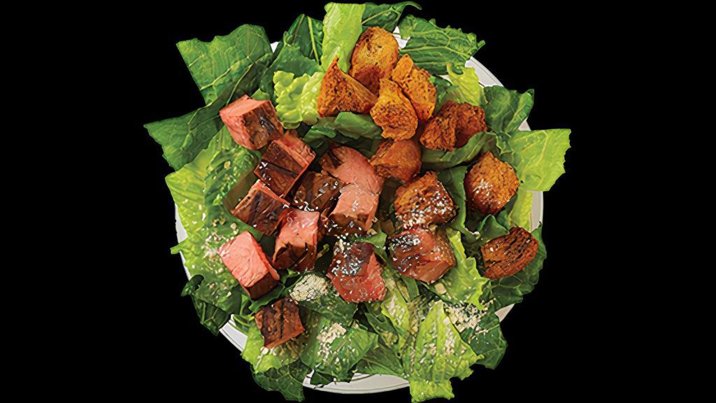 Classic Caesar Bowl · House Croutons, Parmesan, Romaine. Recommended dressing is Caesar Dressing. Shown with Steak.