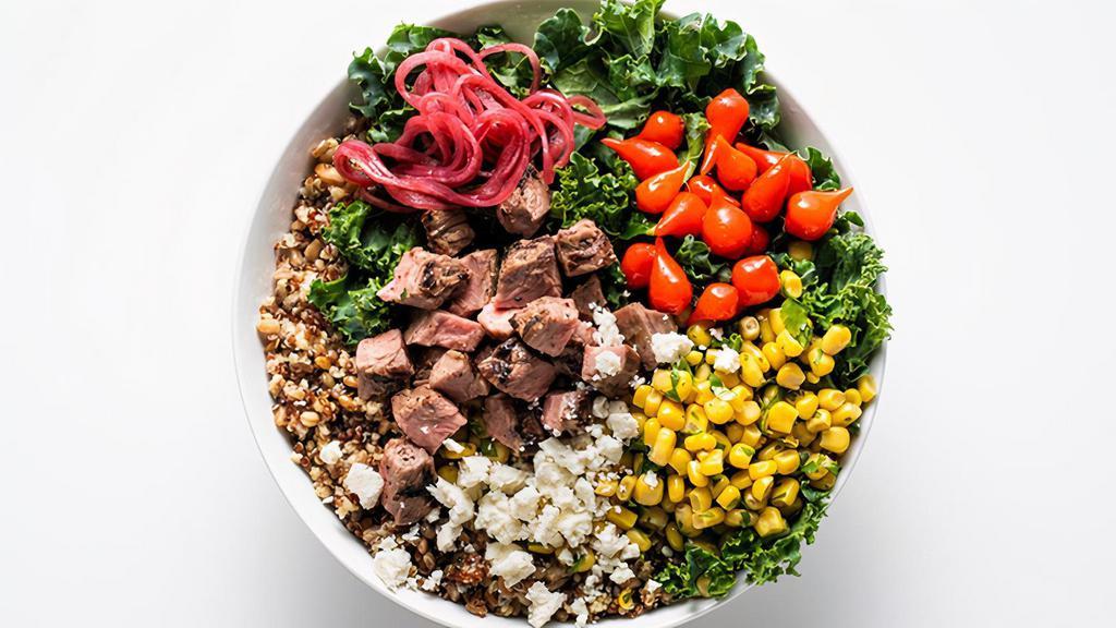 Peruvian Steak Bowl · Grilled Flank Steak, Grain Medley, Sweety Drop Peppers, Corn Salad, Pickled Red Onions, Crumbled Feta, Kale. Recommend Tarragon Vinaigrette