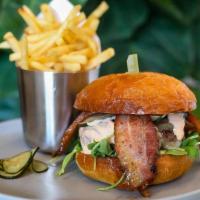 Brunch Burger · white cheddar, caramelized onions, house pickles, arugula, spicy ranch, side of house chips