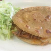 Gorditas · Served with beans, your choice of guiso, lettuce, sour cream, and queso fresco.