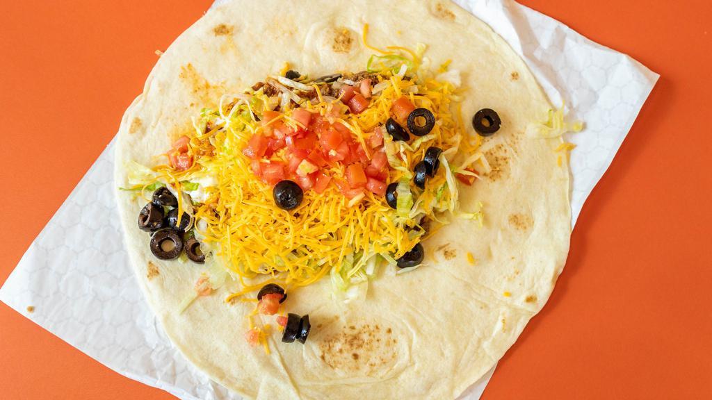 Super Burrito · A steamed flour tortilla filled with refried beans, 100% ground beef, mild red sauce, real sour cream, fresh shredded lettuce, cheddar cheese, tomatoes, and black olives.