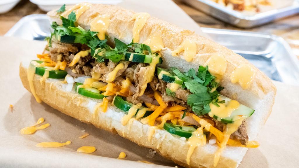 Banh Mi Sandwich · a french baguette filled with your choice of protein, cucumbers, pickled carrots and daikon, firecracker sauce, jalapenos and cilantro