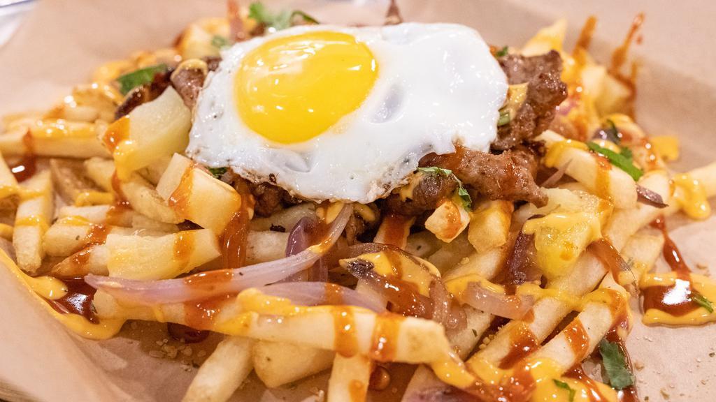 Nom Fries · Our version of loaded fries, you get to choose your protein, on top of french fries. it comes with grilled onions, pineapples, gochujang and firecracker sauce topped with a sunny side up egg and cilantro