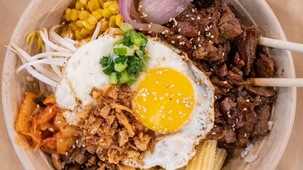 Bibimbap · Literally means mixed rice. Korean inspired sliced beef with rice and sautéed sweet onions, homemade kimchi, soy shiitake, sweet roasted corn, Roasted sesame seeds, crispy shallots, spicy Gochujang sauce Fried egg optional