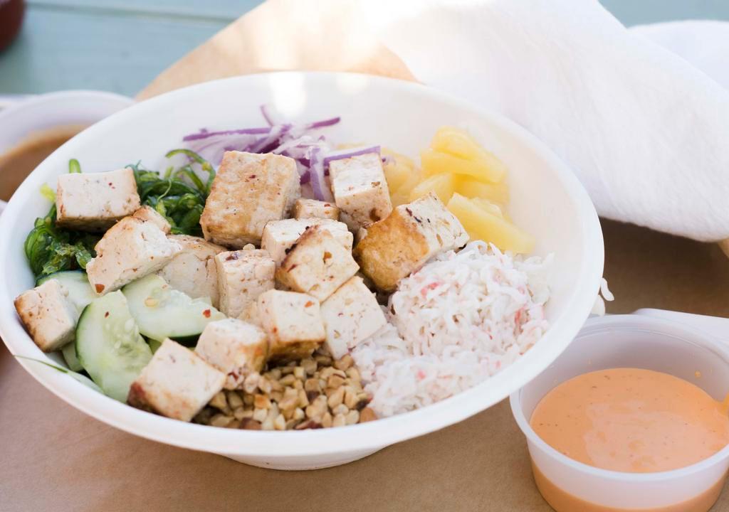 Tantali Tofu Salad Bowl · Perfect lean dish without sacrificing flavor. Organic local tofu infused with lemongrass and red peppers on a bed of greens and other veggies. Bowl consists of greens, bean sprouts, cucumbers, pickled carrots and daikon, pineapples, red onions, wonton strips. boiled egg optional