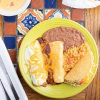 El Caballero · Spicy beef burrito with chili con queso, chicken enchilada with sour cream sauce, cheese & o...