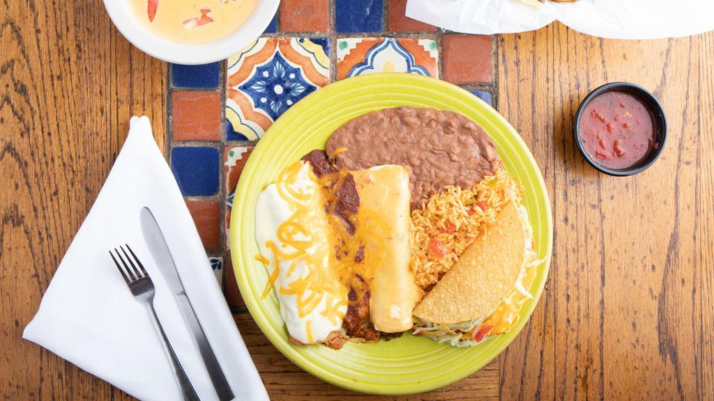 El Caballero · Spicy beef burrito with chili con queso, chicken enchilada with sour cream sauce, cheese & onion enchilada with chili con carne & a crispy chicken taco. With rice & re-fried beans.
