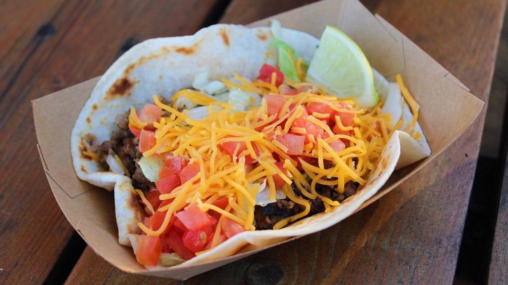 #13 Texican · Tex-Mex beef, lettuce, tomato, cheese (served on a flour tortilla).