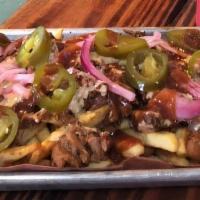 Texas Poutine Fries · Seasoned French Fries loaded with pulled pork or chopped beef, beans, jalapenos, pickles oni...