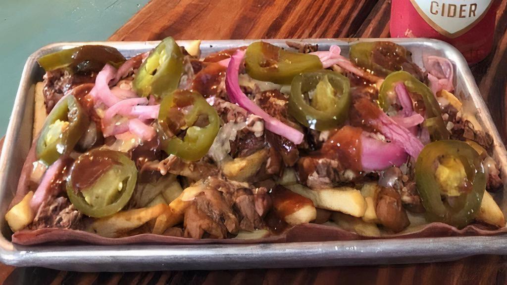 Texas Poutine Fries · Seasoned French Fries loaded with pulled pork or chopped beef, beans, jalapenos, pickles onions and our house-made queso