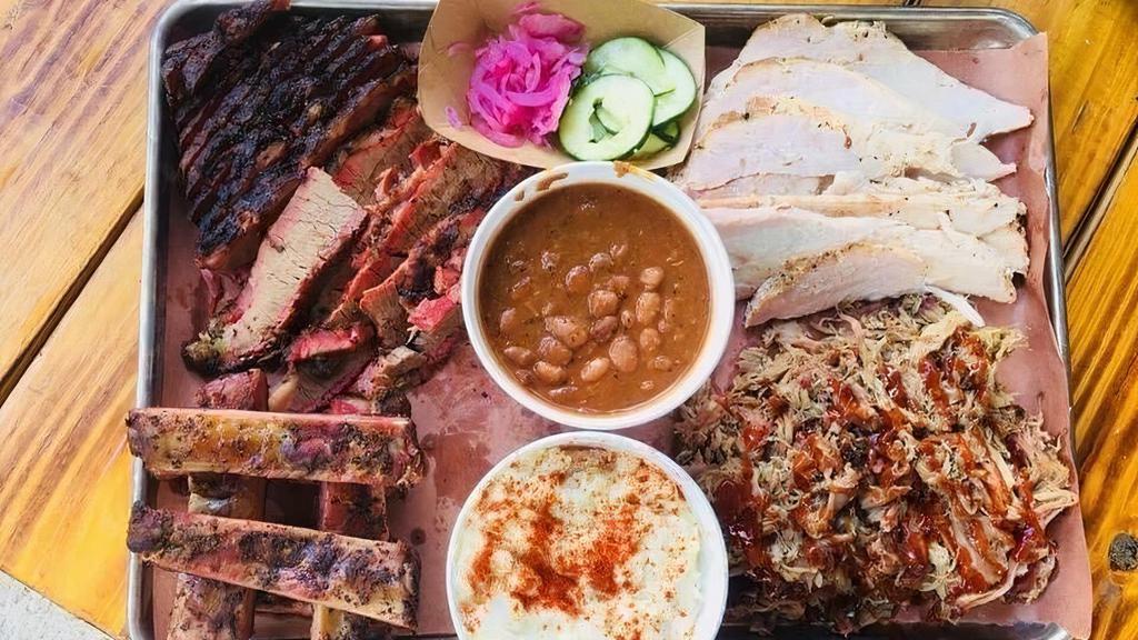 Sampler · All sample of four meats with your choice of two sides and three slices of bread and a 1.5 ounce of BBQ sauce. Brisket. Turkey. Sausage and pulled pork .