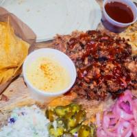Taco Family Pack W/Chips And Queso  And Large Burnt End Beans · Our Taco Family Pack  come with 1.5 lbs of pulled pork, 8 tortillas, jalapeños, onions, slaw...