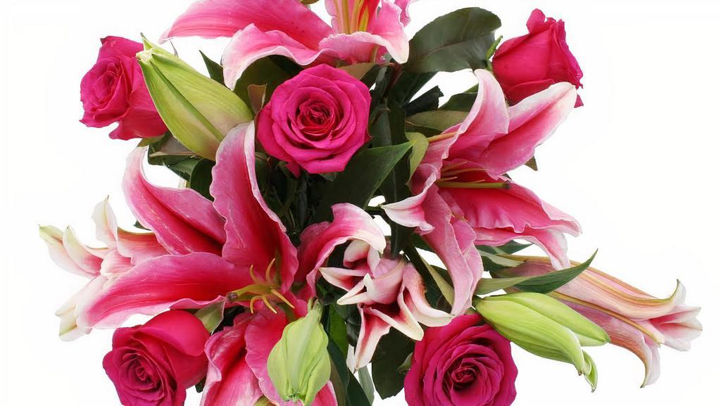 Debi Lilly Fragrant Rose Bouquet · Classic 6 red roses, two stems of lilies and greens wrapped in a kraft wrap.