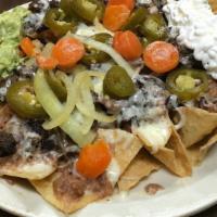 Nachos La Esperanza · Corn tortilla chips topped with beans, meat, melted cheese, sour cream, guacamole & jalapeño.