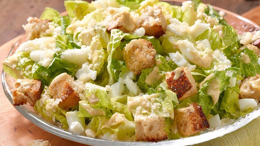 Caesar Salad · Chopped romaine served with a side of Caesar dressing, grated Parmesan, and croutons.