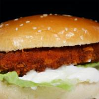 Chicken Sandwich · Golden chicken breast sandwich with lettuce, pickles and mayo served on a bun.