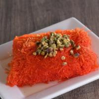 Kunafa · Noodle pastry stuffed with sweet cheese and draped in floral syrup and topped with pistachios