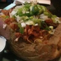 Loaded Baked Potato · Large Potato served w/ Butter, Bacon, Sour Cream, Chives & Mixed Shredded Cheese