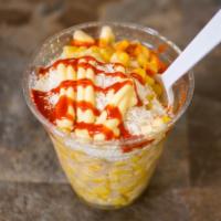Elotes · Corn with cotija cheese, mayonnaise, sour cream, and butter.