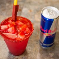 Red Bull Preparado · Red bull with the lime juice, chamoy and tajin topped with watermelon chunks.