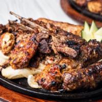 Grilled Platter · Chicken tikka leg, Chicken Boti, Chicken and Beef seekh kebab served on a sizzling skillet.