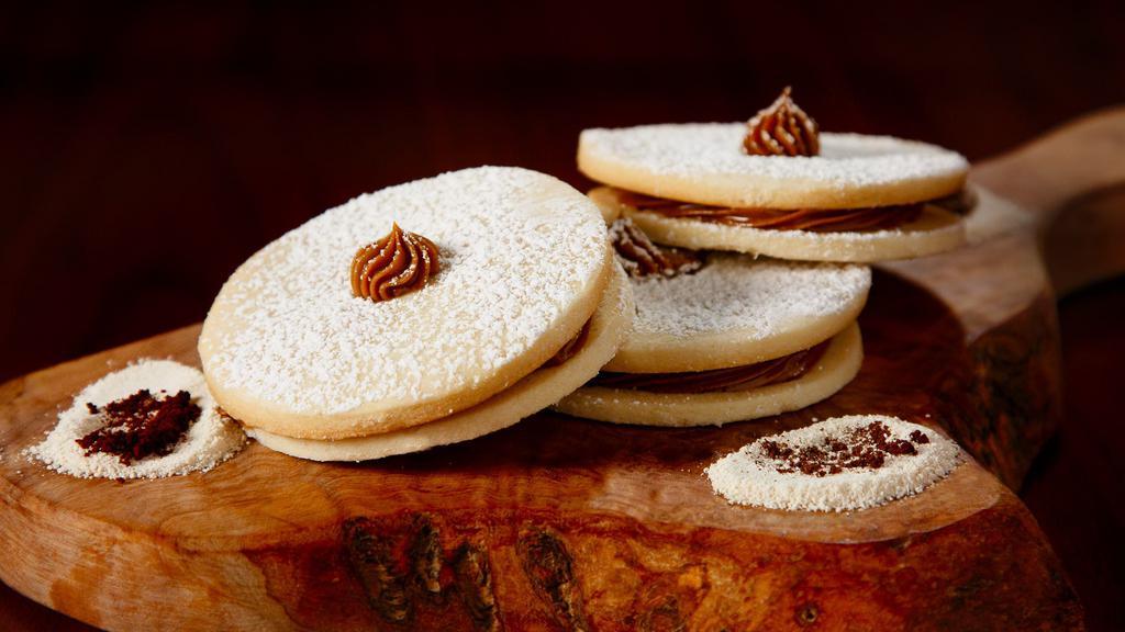 Alfajor · One home made shortbread cookie with home made caramel filling and powdered sugar on top. 
(Picture shows 3)