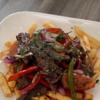 Lomo Saltado Beef · Sirloin beef onions tomatoes green peppers topped over french fries.